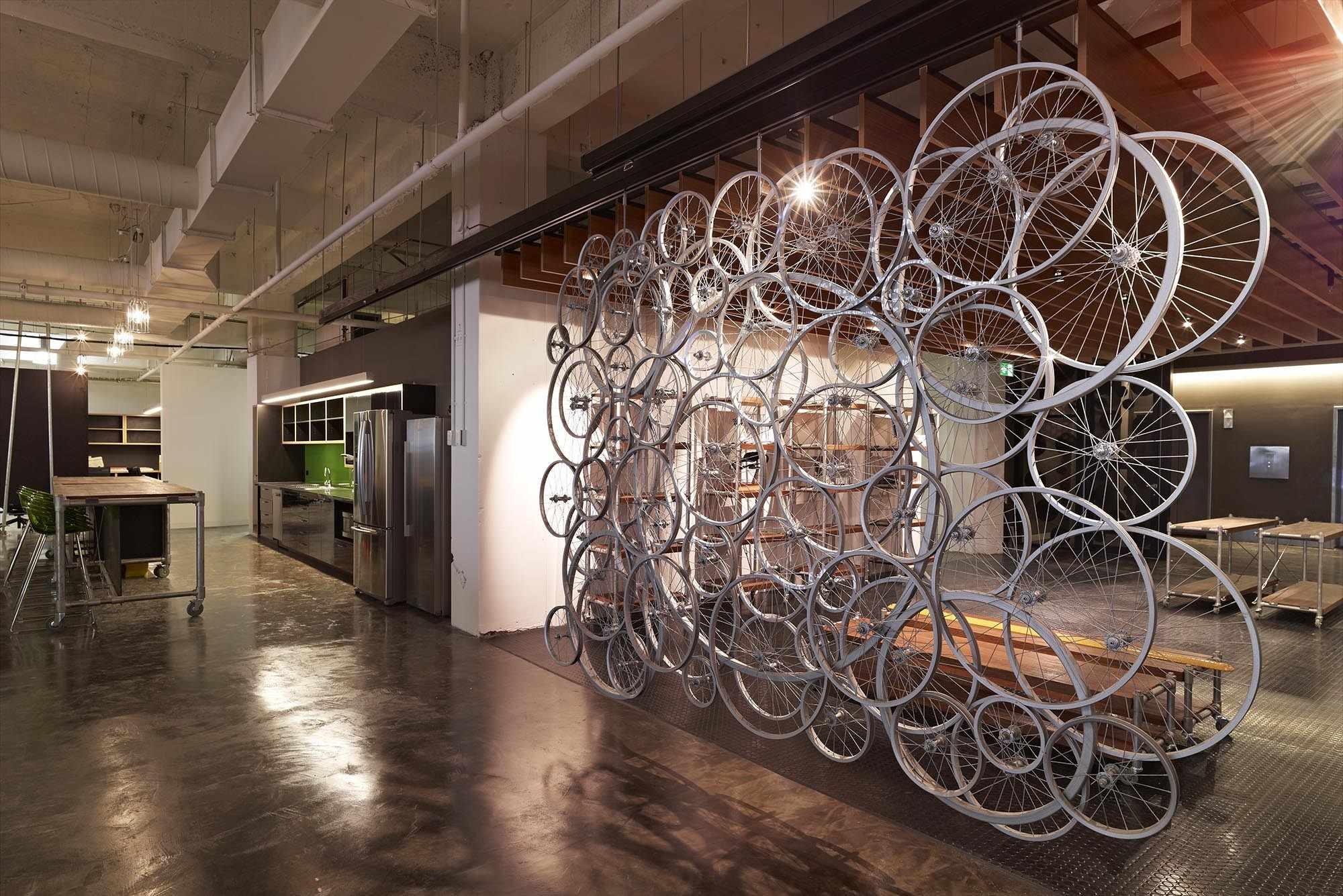 Bicycle Netword Office Fitout showing bike wheels as partition, polished floor and natural tones