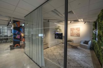 Office workspace divided into functional sections to allow for acoustics and work. Melbourne Office design by IN2 SPACE Interior Design and Project Management