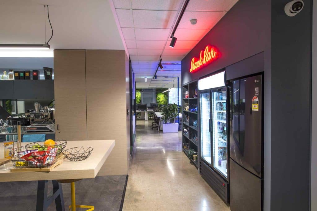 staff snack bar, and snack fridge, large kitchen bench, modern decor that considers employees at their workplace