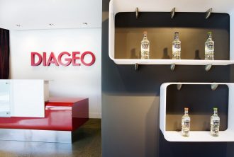 Office interior design showing product placement in boxes on the wall and bold logo colours behind reception desk