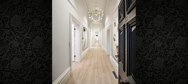 long hallway with modern lighting and white walls