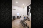 non-surgical-medical-room-design-light-floorboards-medical-chair-white-vanity-desk-art-on-wall-showing-face