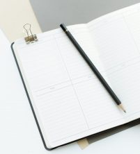 open diary with pencil ready to plan office relocation