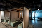 co-work space with two booths encased in wooden vertical slats for privacy