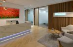 consultancy reception neutral tones, desk, coffee table and glass partitions to meeting rooms