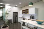 Modern Office kitchen design with cetnre bench and stainless steel appliances